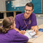 Teacher sitting with a student