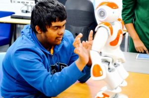 a picture of a student interacting with the robot