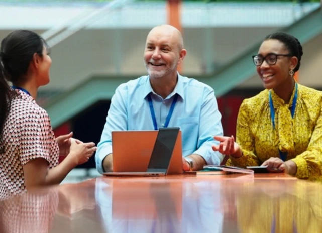 SLT sat around a table in a modern school